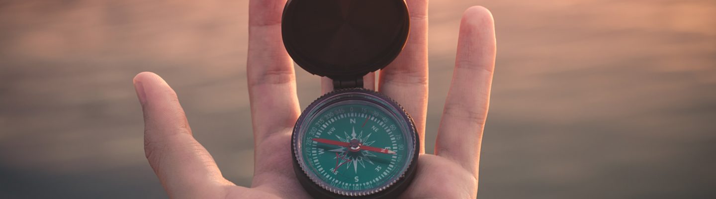 hand holding compass