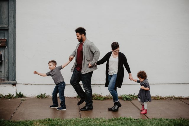 Family of four walking down the street