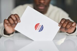 Closeup of a man casting a ballot in a ballot box